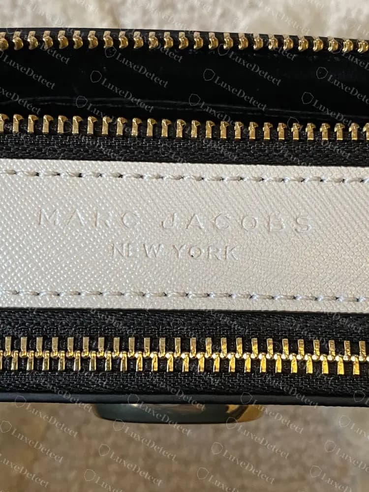 Authentic earlier Snapshot divider strip stamped MARC JACOBS over NEW YORK between the two zips