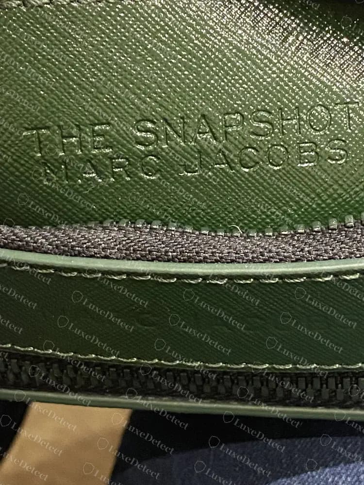 Counterfeit Snapshot DTM with a correct-looking THE SNAPSHOT / MARC JACOBS patch, which is why the patch alone cannot clear a bag