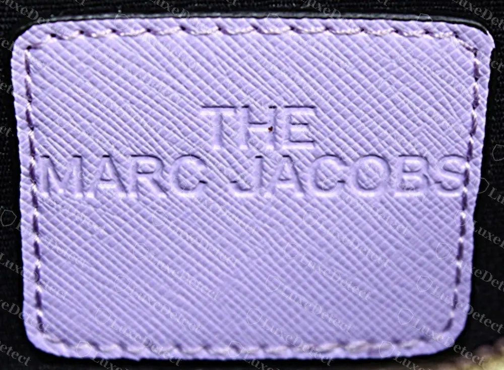 Counterfeit Snapshot interior patch stamped THE over MARC JACOBS instead of THE SNAPSHOT over MARC JACOBS