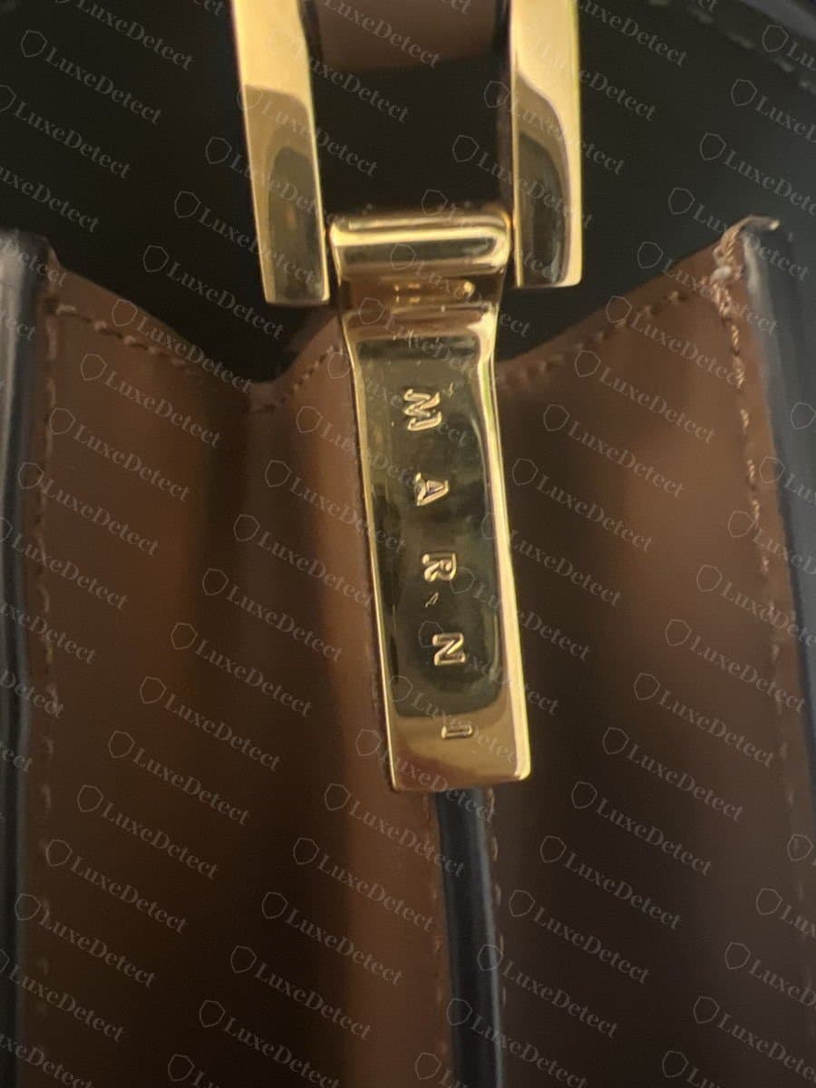 Genuine Marni Trunk hardware: a solid gold-tone fitting with the MARNI lettering cleanly engraved