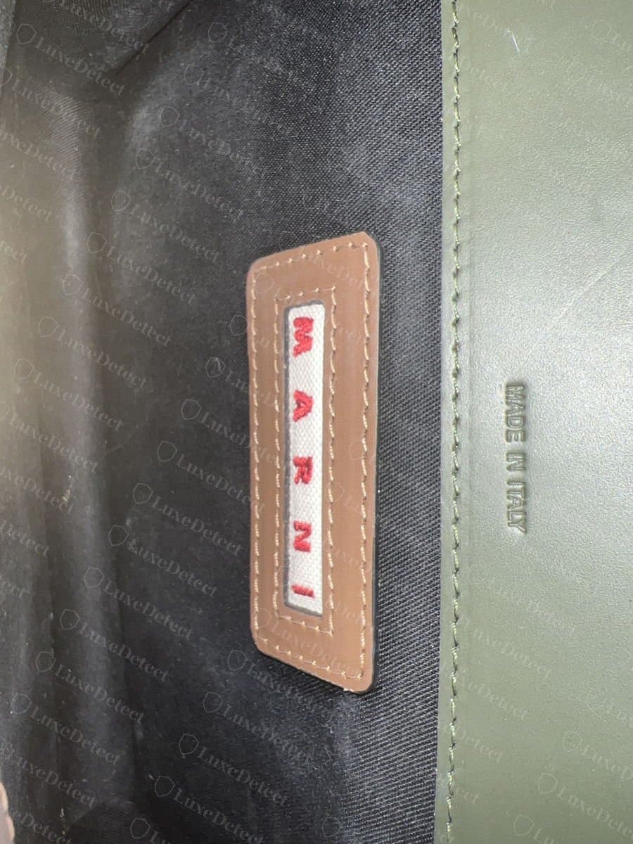 Genuine Marni Trunk interior: the sewn MARNI label with flat, even stitching, beside the MADE IN ITALY marking pressed into the leather