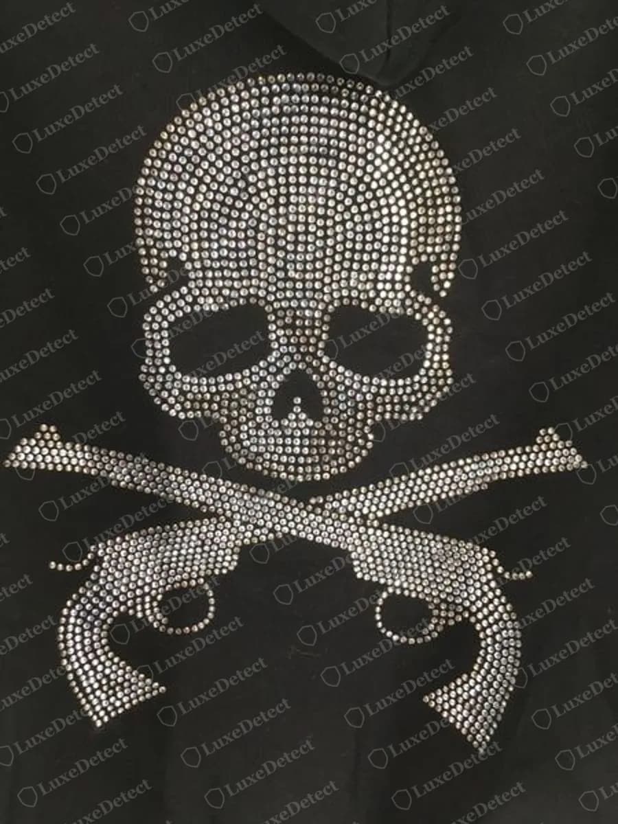 Echter Mastermind Japan Strass-Rückendruck: ein Totenkopf über zwei gekreuzten Pistolen, aus kleinen klaren Steinen in Reihen auf schwarzem Fleece aufgebaut