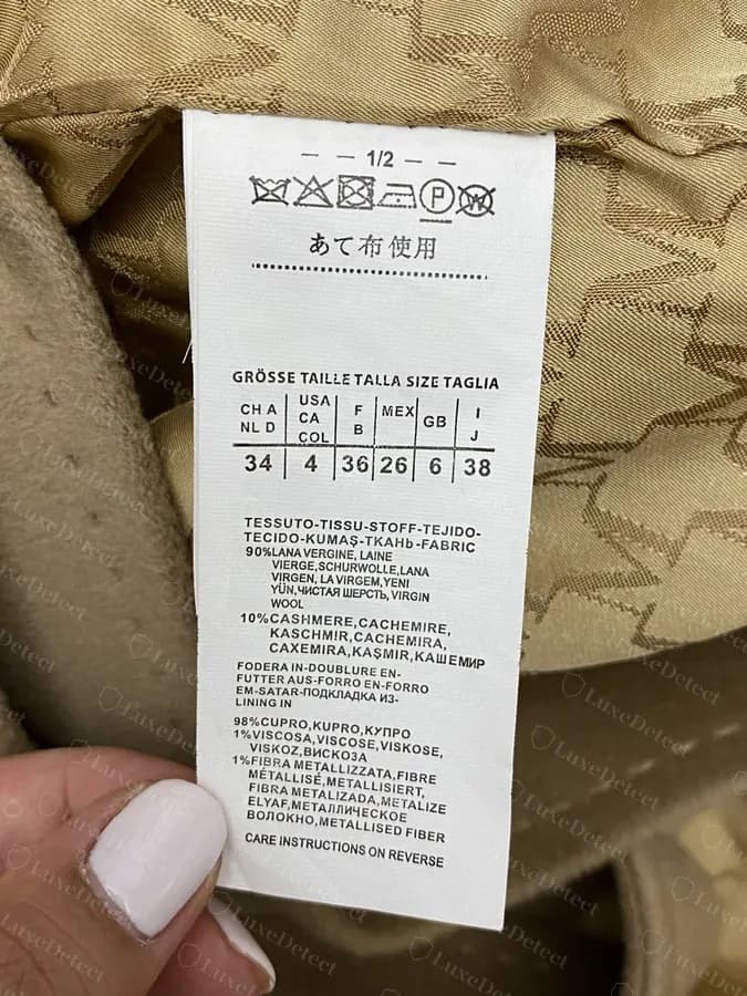 Authentic composition label from a genuine MaxMara garment showing the multi-language fabric block and full size grid.
