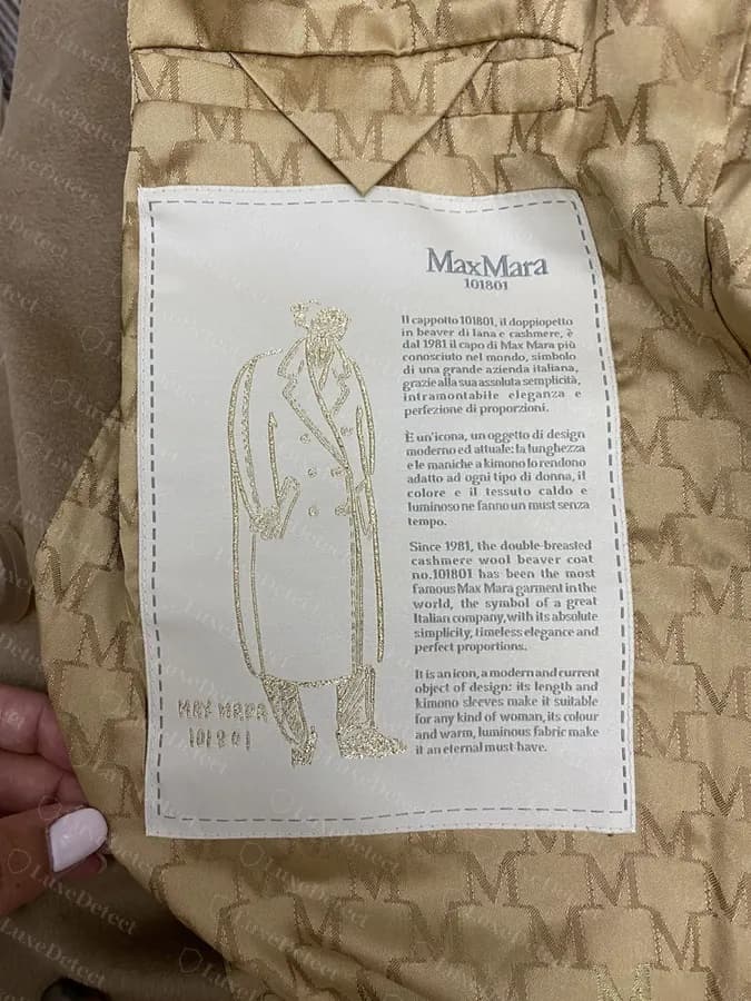Authentic MaxMara heritage tag on the 101801 Teddy Bear coat, showing the brand illustration and Italian/English text block.