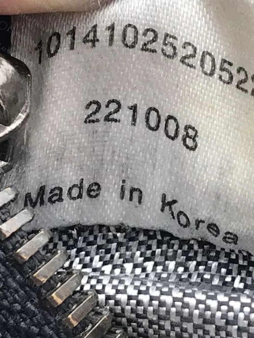 Counterfeit interior tag: a 13-digit number over a six-digit line and Made in Korea, with no style code
