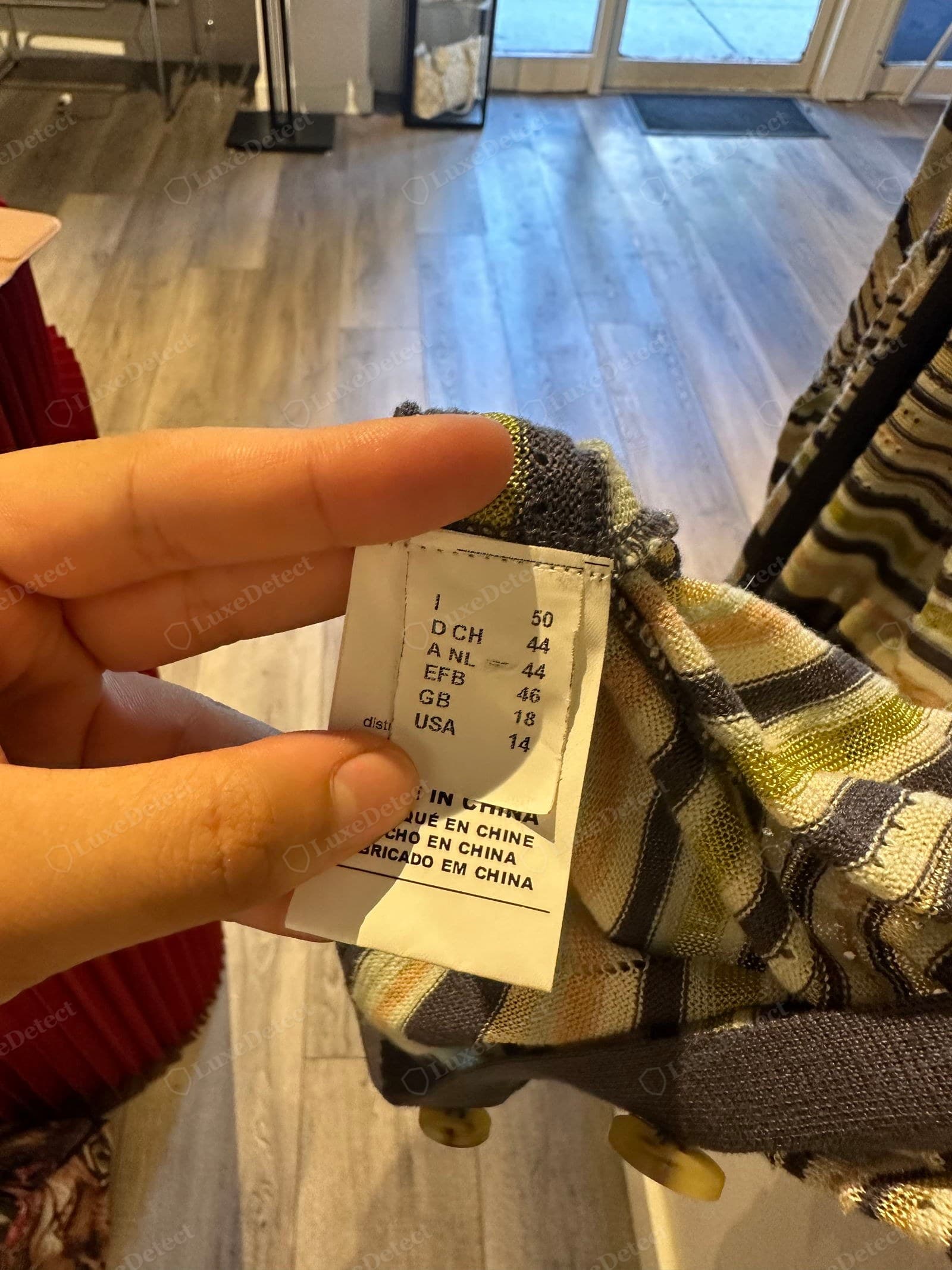 Counterfeit Missoni label — a care-and-size label reading "MADE IN CHINA" (in French, Spanish and Portuguese too), on a thin space-dyed knit; genuine mainline and M Missoni knitwear is made in Italy