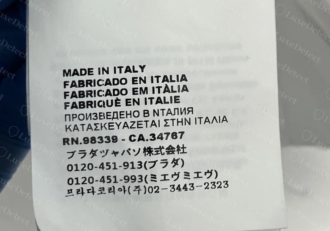 Counterfeit care label: the Japanese importer line reads ブラダヅャバソ and (ミエヴミエヴ), the Russian line has a Latin N in ИТАЛИЯ, and the French reads FABRIQUÈ.