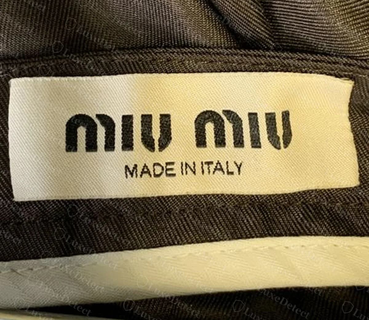 Genuine Miu Miu woven neck label: "miu miu" in the house's split-stroke lettering over "MADE IN ITALY".