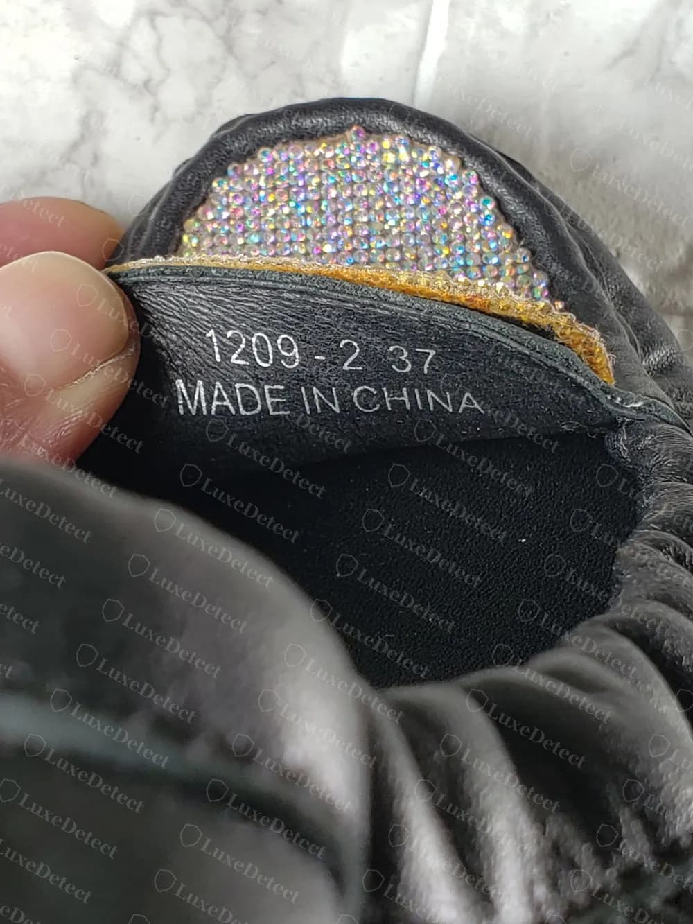 Counterfeit Miu Miu crystal-toe ballerina lining: factory lot number "1209-2 37" and "MADE IN CHINA"