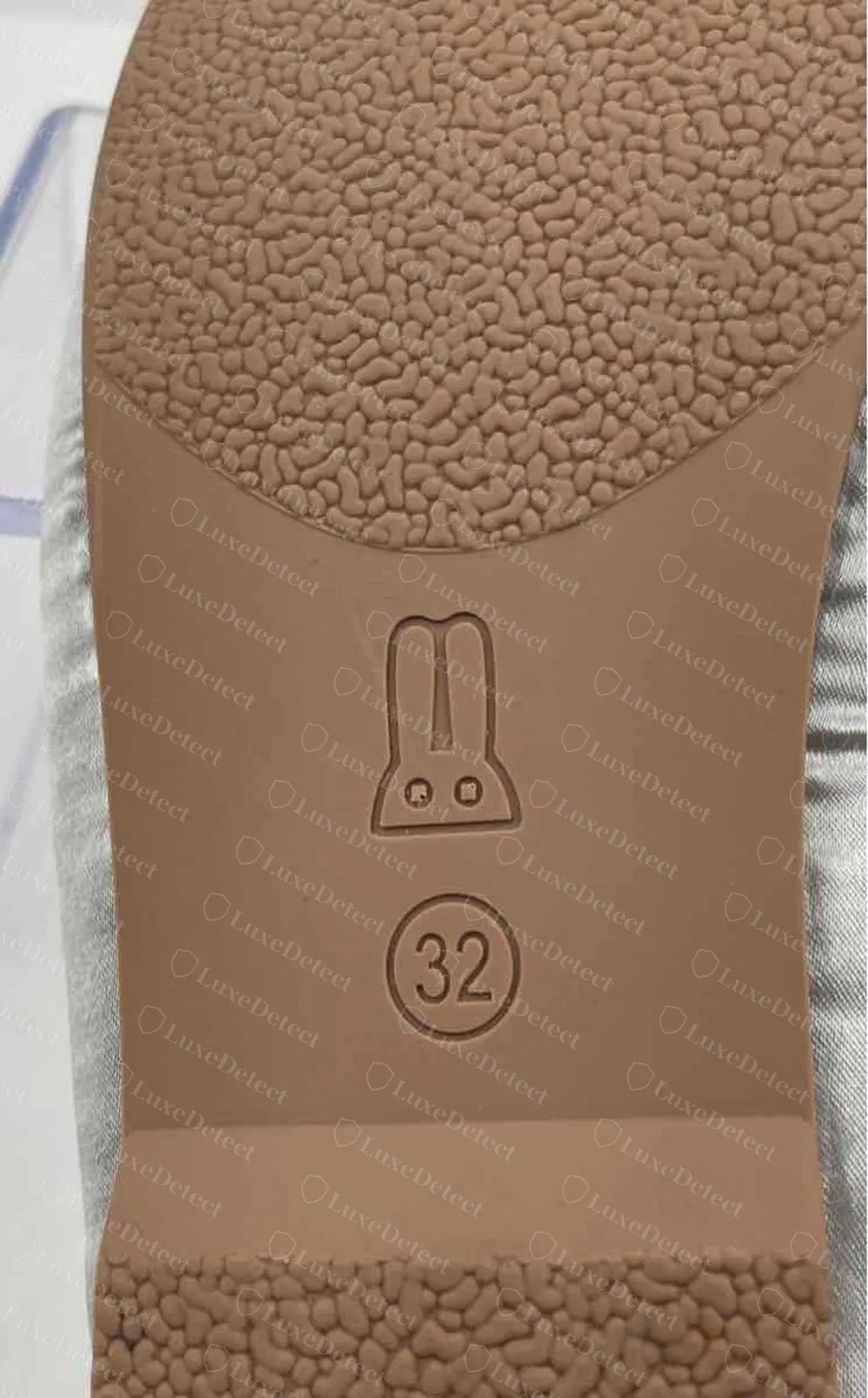 Counterfeit Miu Miu ballerina flat: a circled "32" moulded into the rubber sole next to a rabbit pictogram