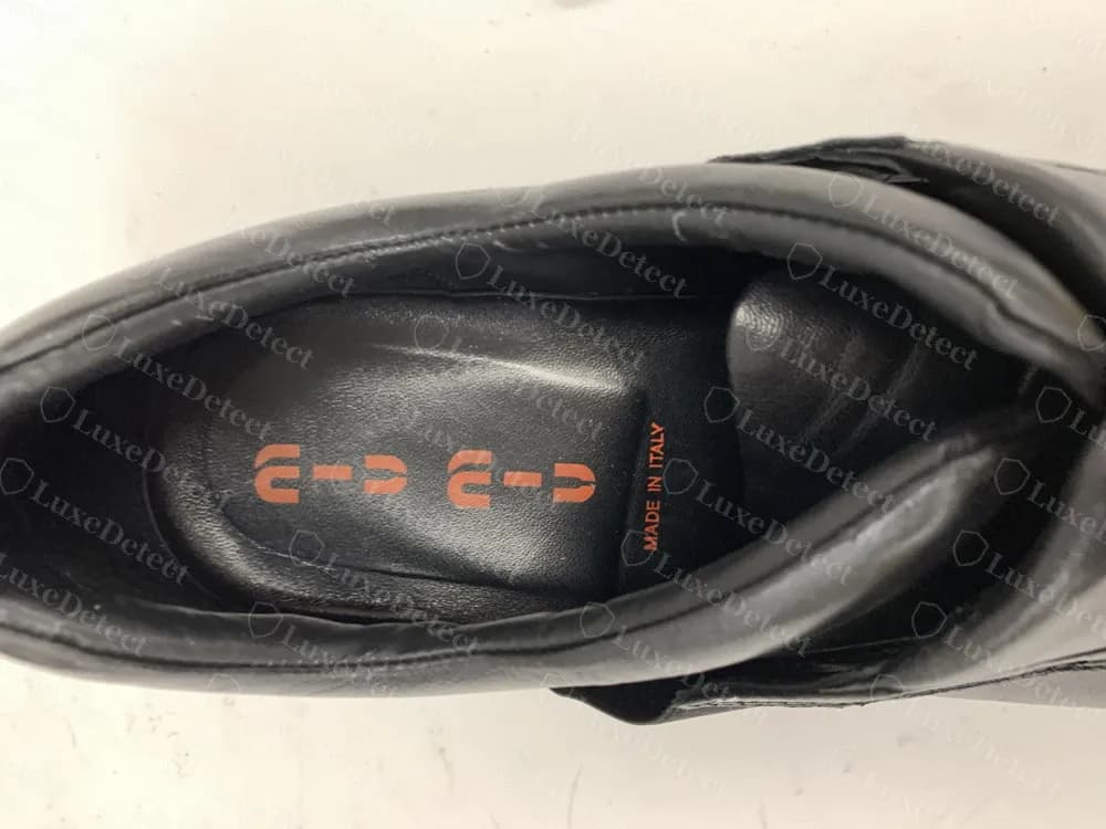 Authentic Miu Miu sport-line shoe insole with the segmented orange wordmark and "MADE IN ITALY", a genuine format that looks unusual