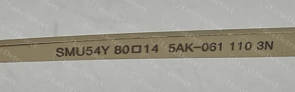 Authentic rimless Miu Miu temple of the same model reading "SMU54Y 80□14 5AK-061 110 3N", evenly spaced
