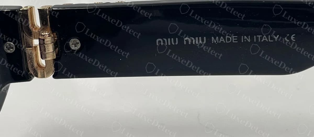 Counterfeit Miu Miu brand line reading "miu miu MADE IN ITALY CE" with no factory letter between the origin and the CE mark