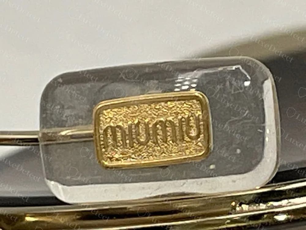 Authentic Miu Miu nose pad with the gold "miu miu" plate set into clear silicone
