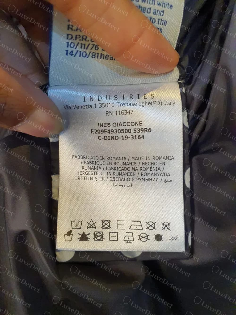 The care label of a genuine women's Moncler jacket with a style code that carries a letter where most codes have a digit, and the production code C-DIND-19-3164