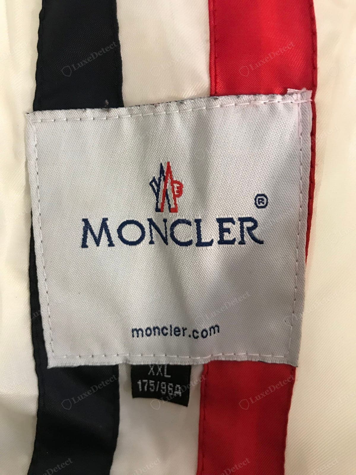 Counterfeit Moncler interior logo label — a printed or crude-weave label, a fuzzy logo