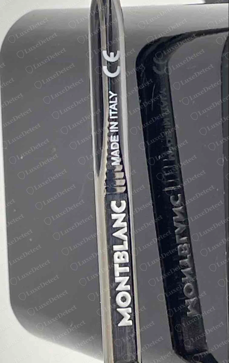 Genuine Montblanc glasses: the outer face of a dark metal temple printed MONTBLANC, with MADE IN ITALY and a CE mark above it