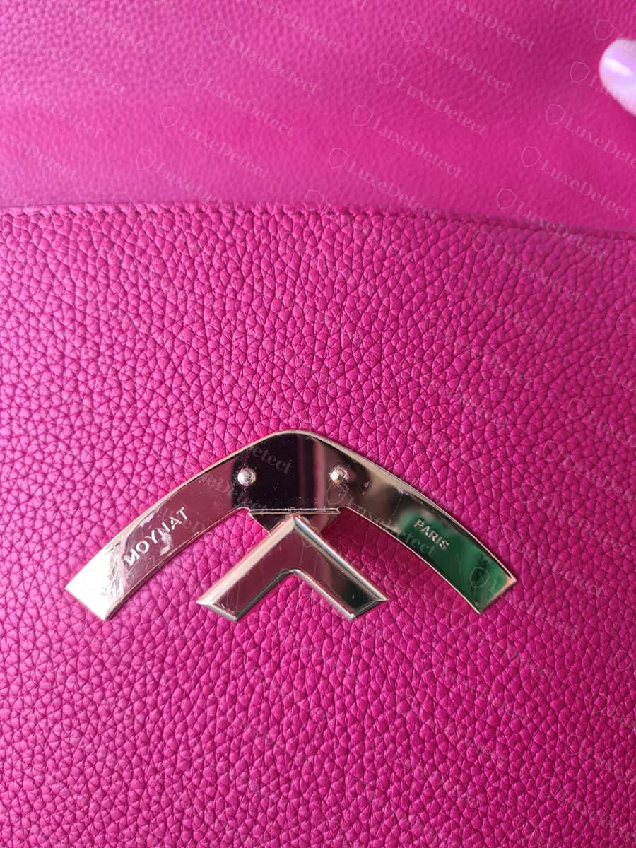 Counterfeit Moynat Gabrielle chevron clasp engraved MOYNAT and PARIS, closely matching the genuine layout