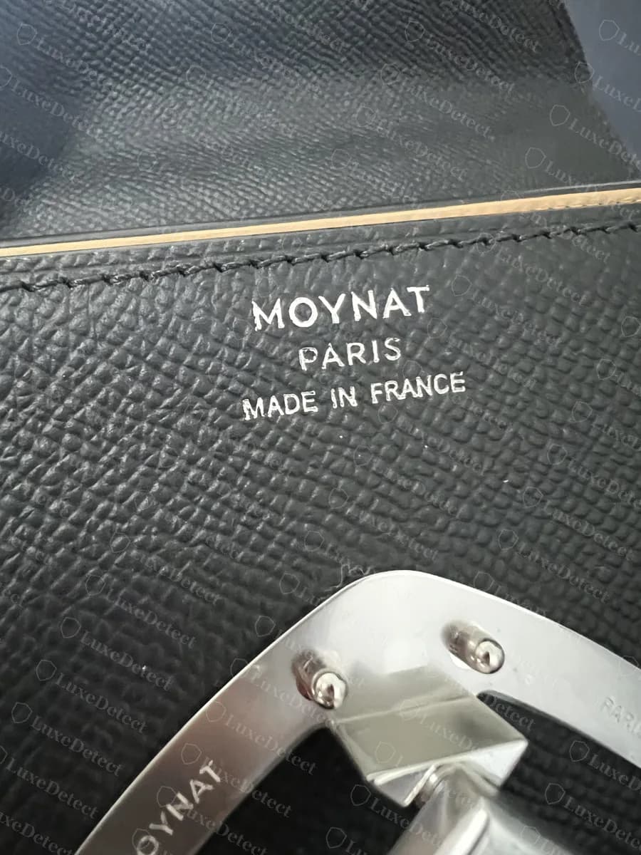 Genuine Moynat Gabrielle interior stamp reading MOYNAT PARIS MADE IN FRANCE in three lines of fine silver foil above the clasp plate