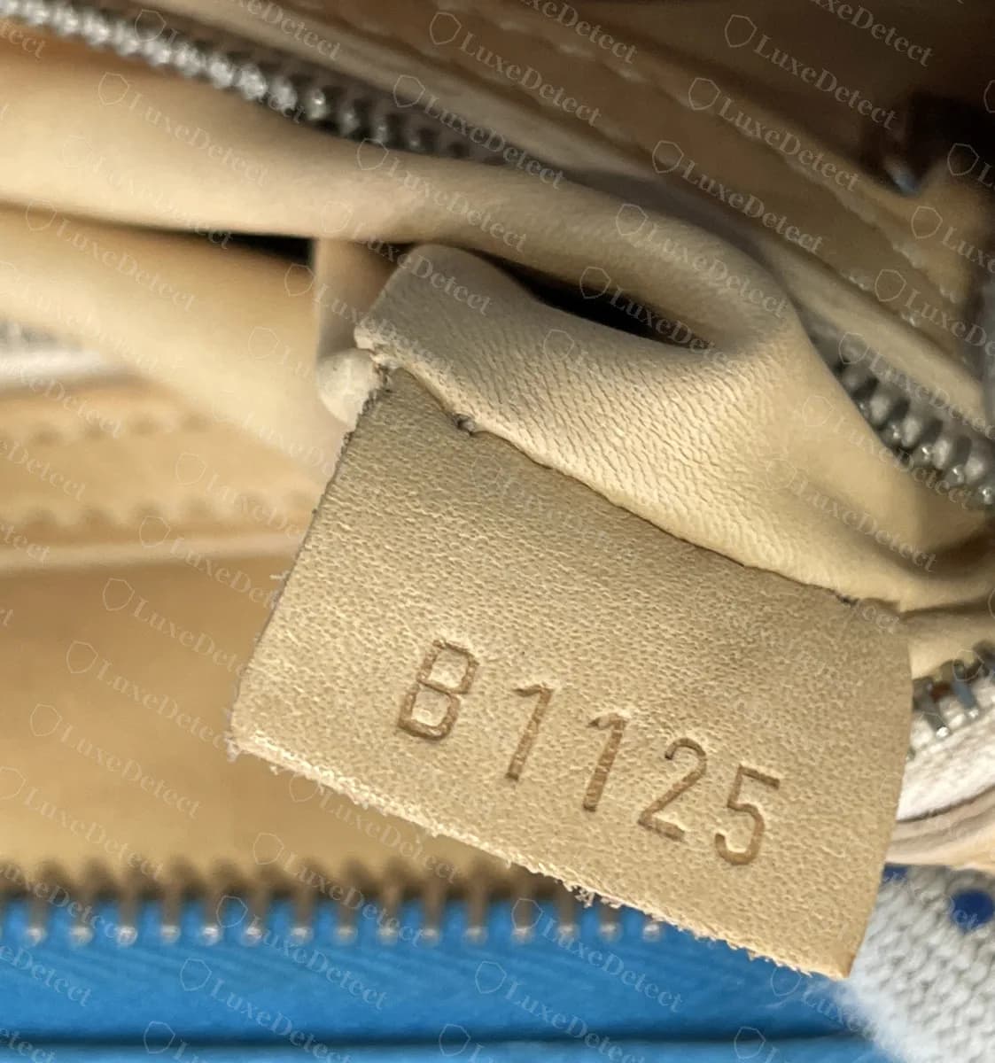 Genuine Moynat interior leather tab heat-embossed with the code B1125