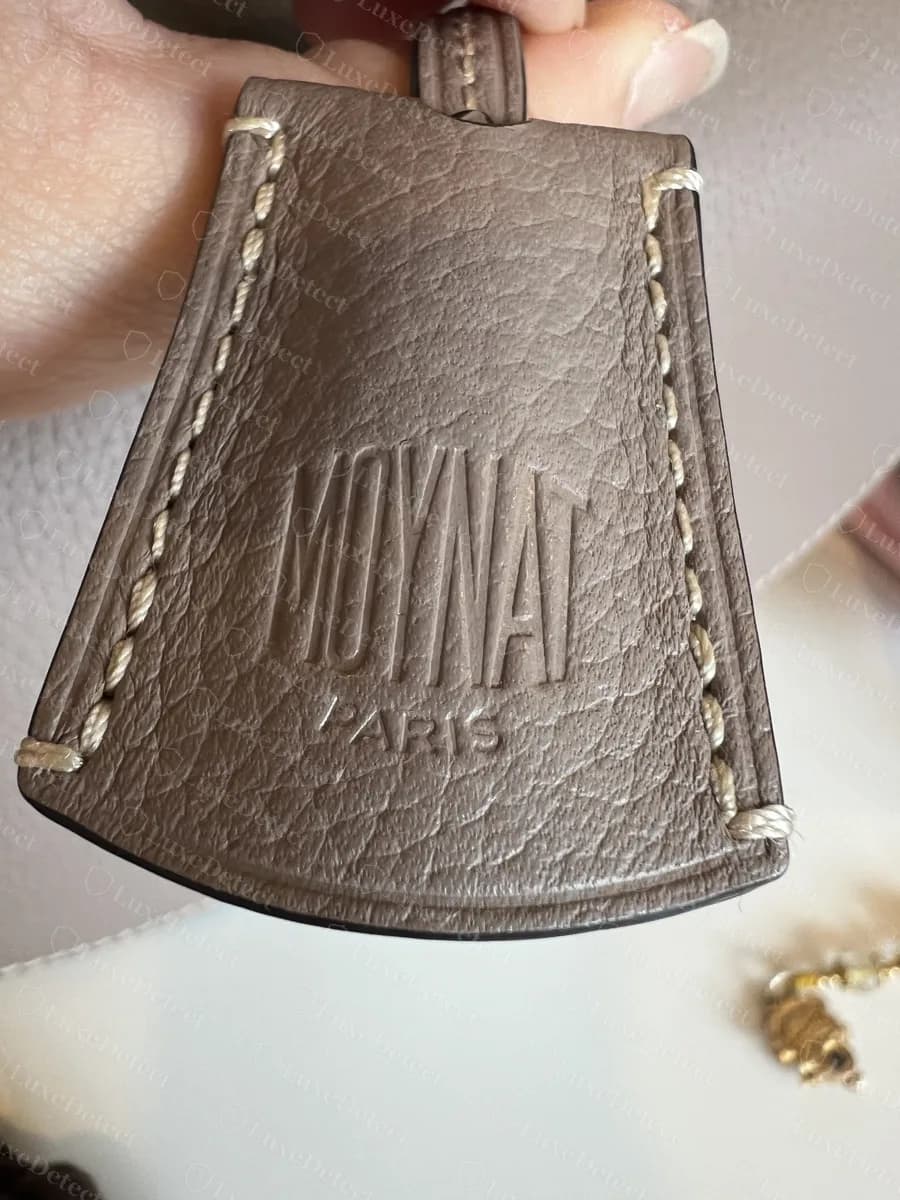 Genuine Moynat Flori key holder embossed with the condensed MOYNAT logo over PARIS