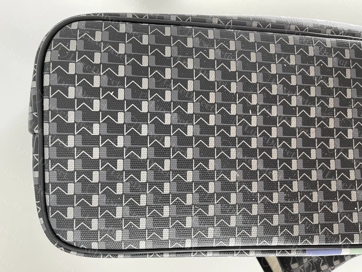 Genuine Moynat coated canvas printed with rows of interlocking stylised M shapes in black and grey