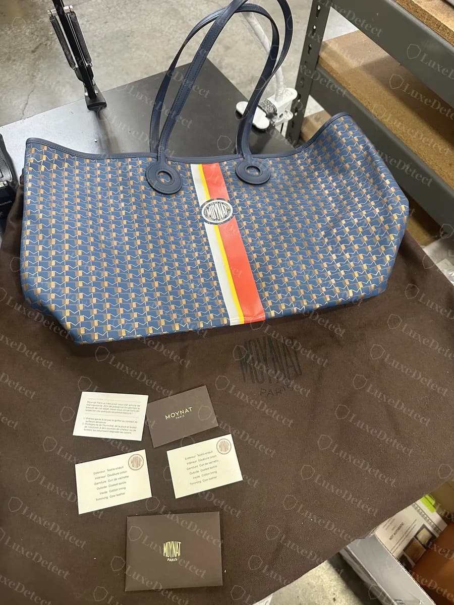 Counterfeit Moynat Oh! Tote GM in navy and gold canvas with an orange, yellow and silver stripe, shown with a dust bag and cards