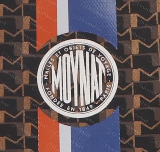 Genuine Moynat Oh! Tote medallion with a condensed MOYNAT inside a ring reading MALLES ET OBJETS DE VOYAGE, FONDÉE EN 1849, PARIS