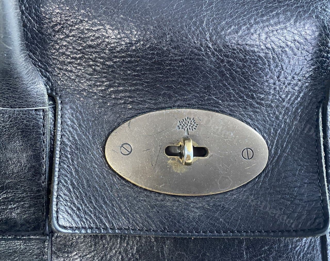 A postman's lock from a listing flagged as counterfeit — visually close to genuine at a glance, underscoring why the lock alone should not carry a verdict