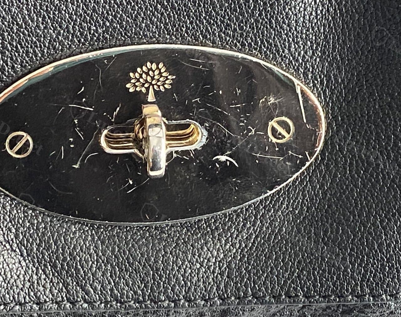 Authentic Mulberry postman's lock — flat-head screws, crisp die-struck tree logo, deep clean "MULBERRY"-adjacent engraving on the oval plate