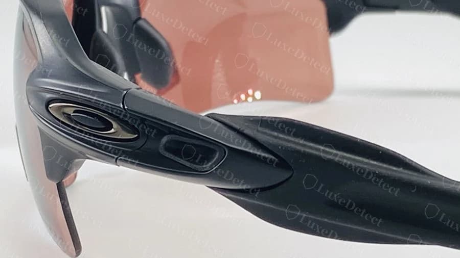 Genuine Oakley Flak O icon and hinge, viewed from the front with the interchangeable nose pad in place