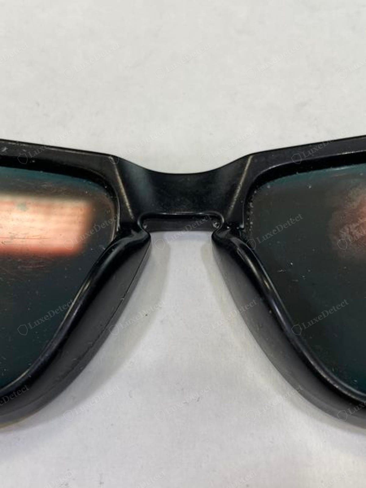 Genuine Oakley nose pad — the Unobtainium nose pad correctly shaped and cleanly fitted to the frame