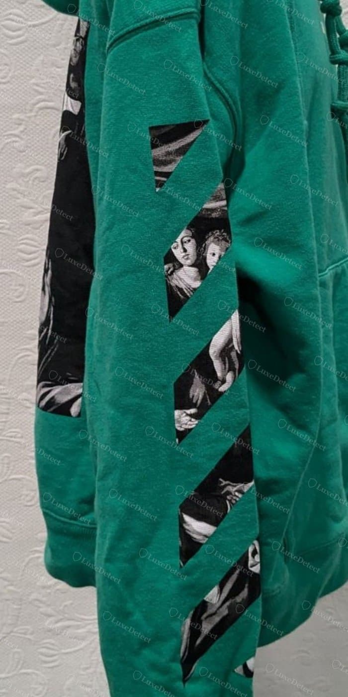 Authentic arrow stripe on a hoodie sleeve: clean geometric diagonal, straight edges, consistent weight throughout