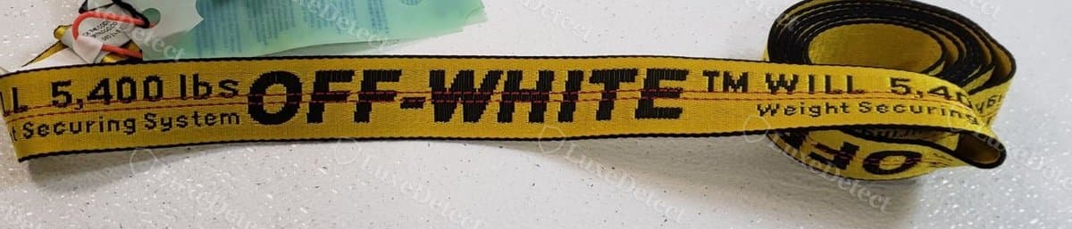 Authentic industrial belt, "OFF-WHITE" set in tall, narrow Helvetica Neue Bold Condensed with tight, even letter spacing