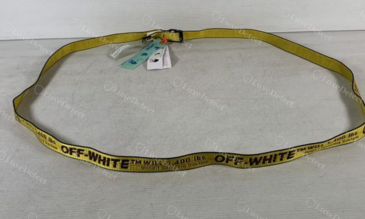 Counterfeit belt shipped with no branded zip tie tag at all — only a generic paper hangtag and authentication card, no "OFF-WHITE™ ZIP TIE" marking anywhere