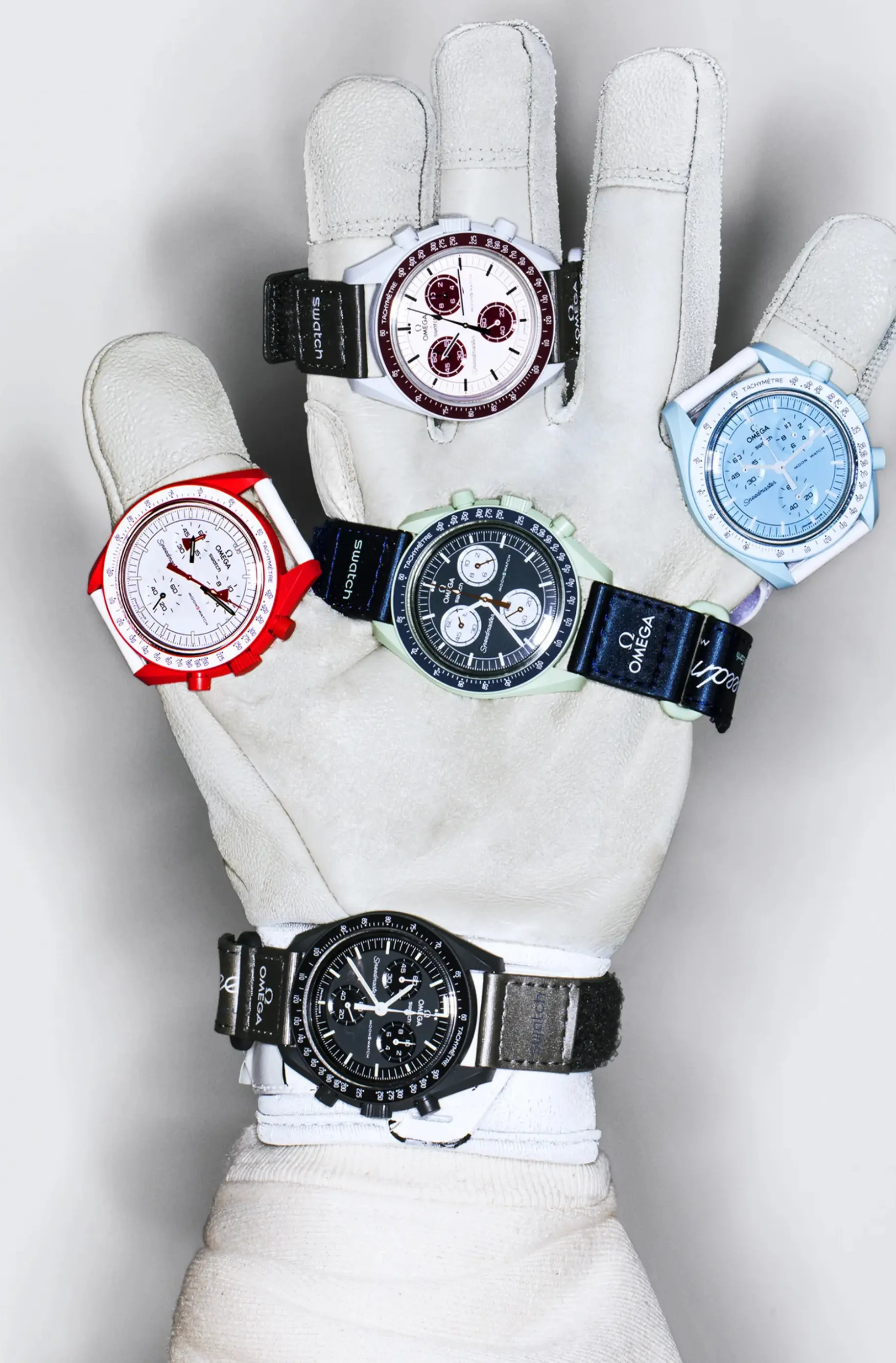 Several genuine MoonSwatch colorways — each pairs a Bioceramic case and tachymeter bezel with a colorway-matched dial and Velcro strap.