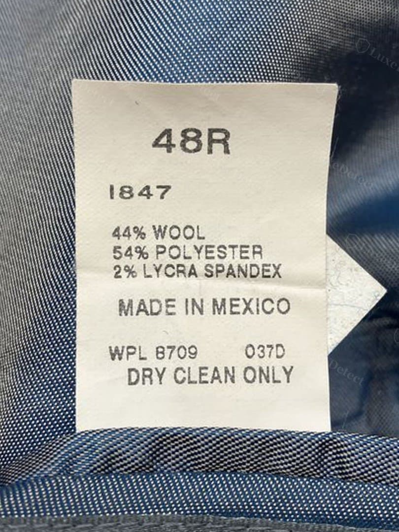 Counterfeit garment's printed care tag — 44% wool/54% polyester/2% lycra spandex blend, Made in Mexico, printed rather than woven