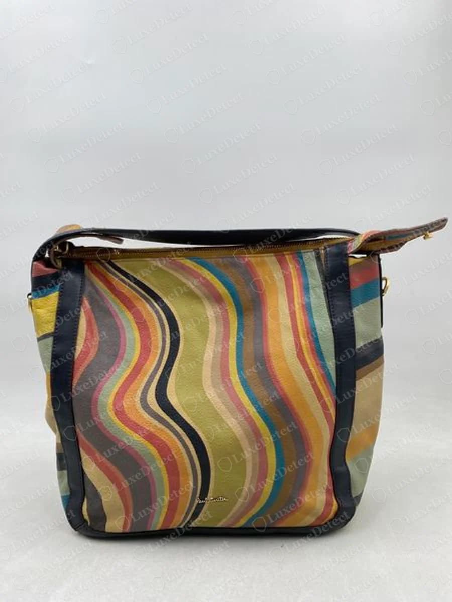 Genuine Paul Smith shoulder bag with a swirling multi-coloured stripe print, navy leather edging and a small script signature near the bottom of the front