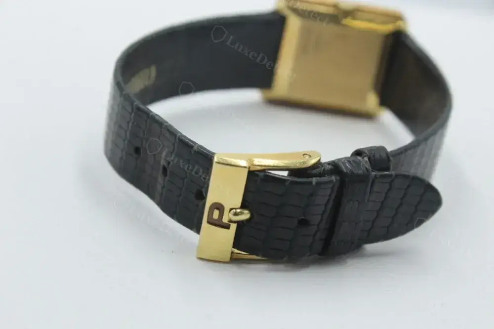 A genuine Piaget buckle, gold "P" stamp on the tongue, matching the dial's branding.