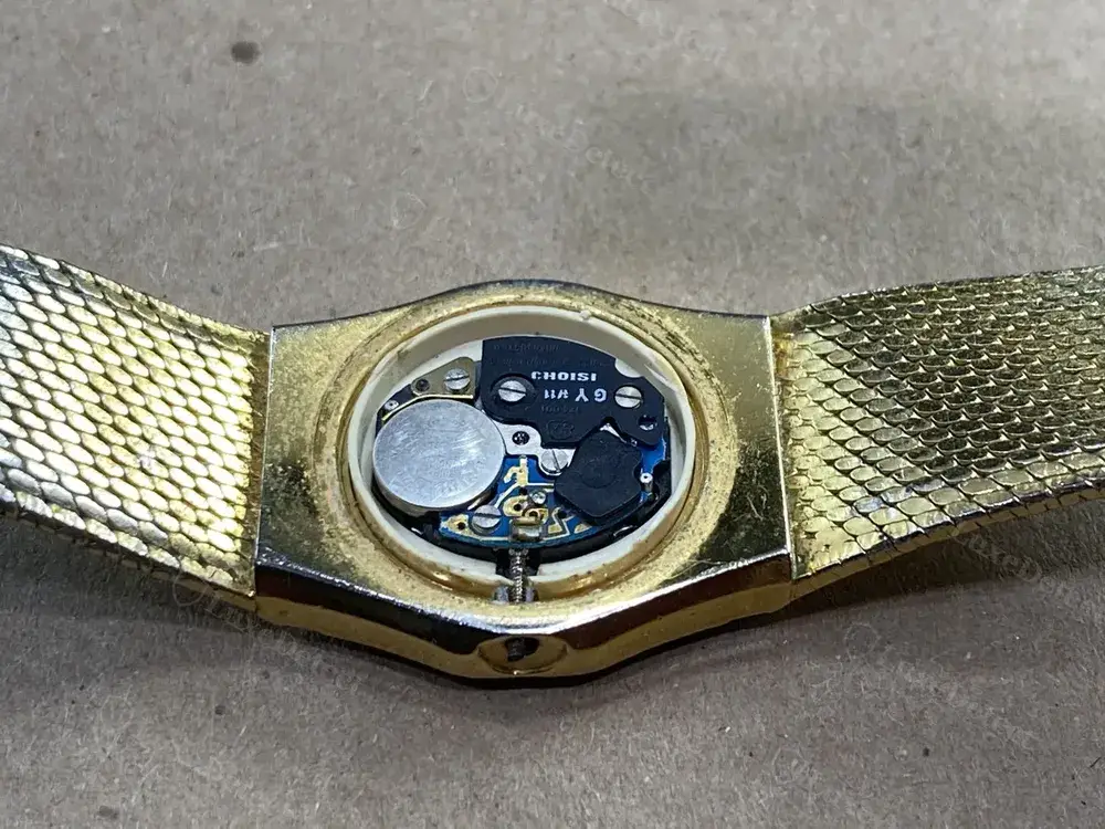 The same authentic watch opened up: a Swiss-signed "CHOISI" quartz module consistent with the dial's claims.