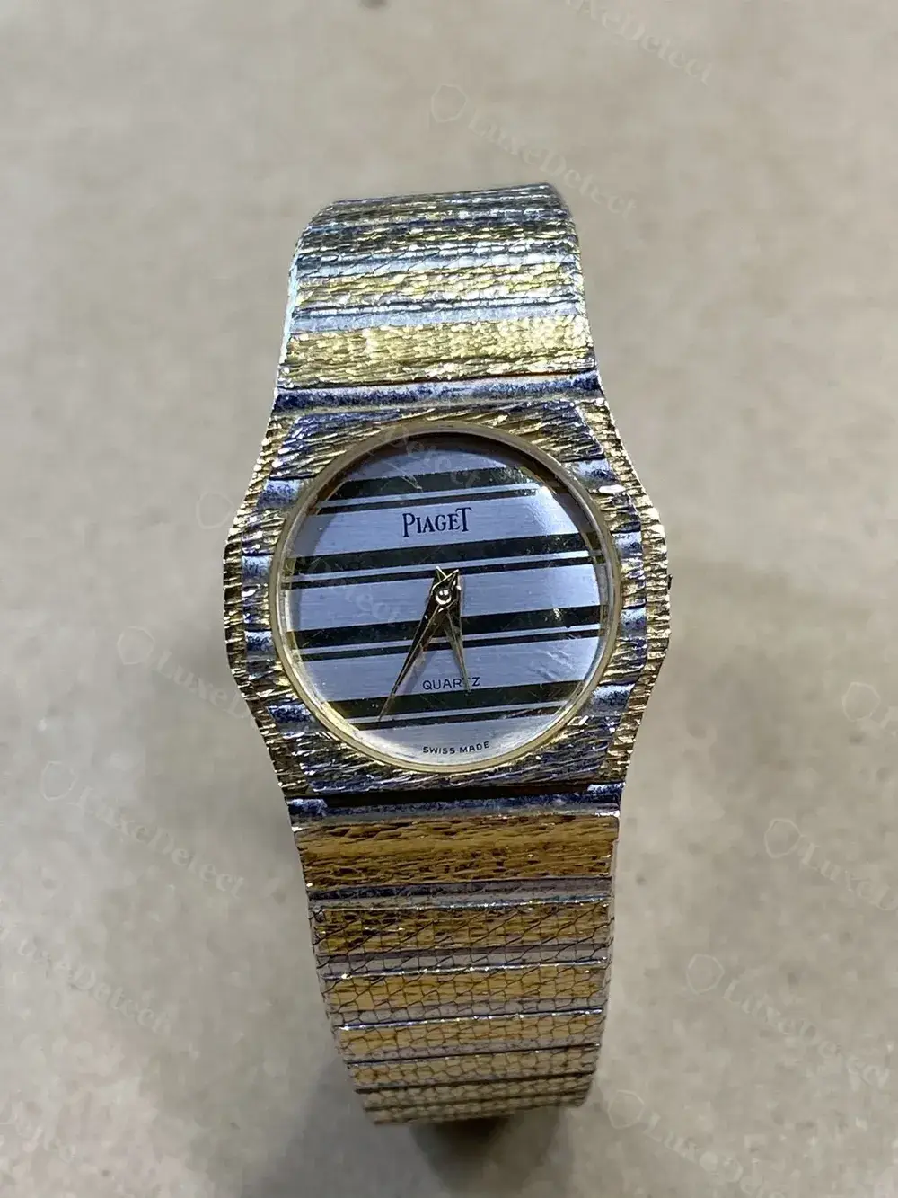 Genuine Piaget Polo-style dial, textured two-tone case, cleanly printed "PIAGET / QUARTZ / SWISS MADE" text.