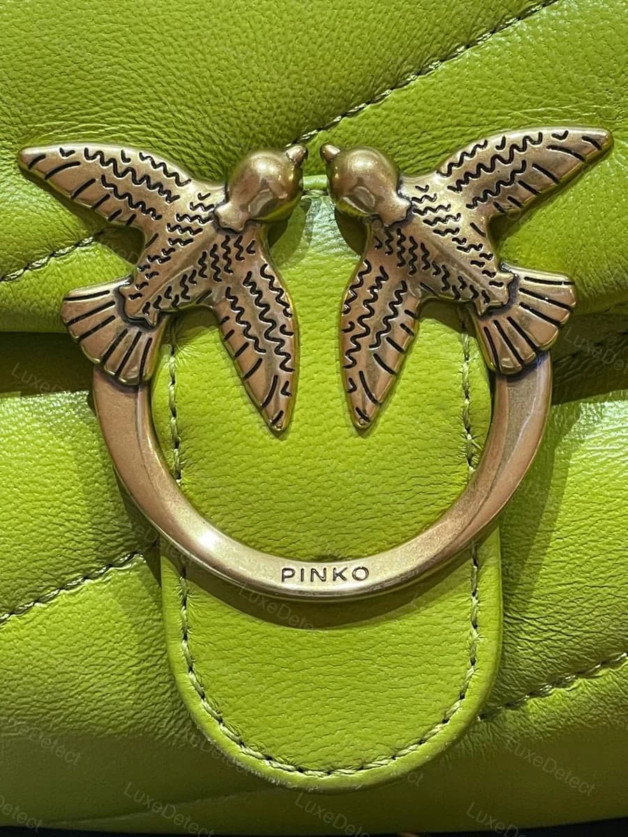 Fake Pinko Love Bag interior (green), showing only a cloth "Made in China" tag in the photographed area, no leather brand tag visible