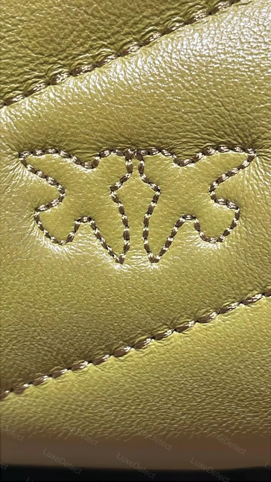 Fake Pinko Love Bag quilting, close-up of the chevron stitch line, showing a slightly wavering, unevenly pitched zigzag rather than a crisp uniform V
