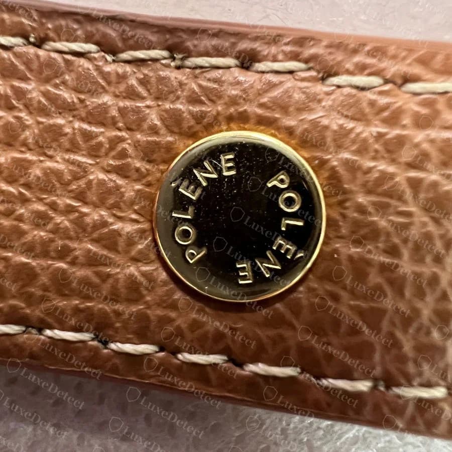 Genuine Numéro Dix strap stud engraved POLÈNE twice around the rim, on camel leather with cream stitching