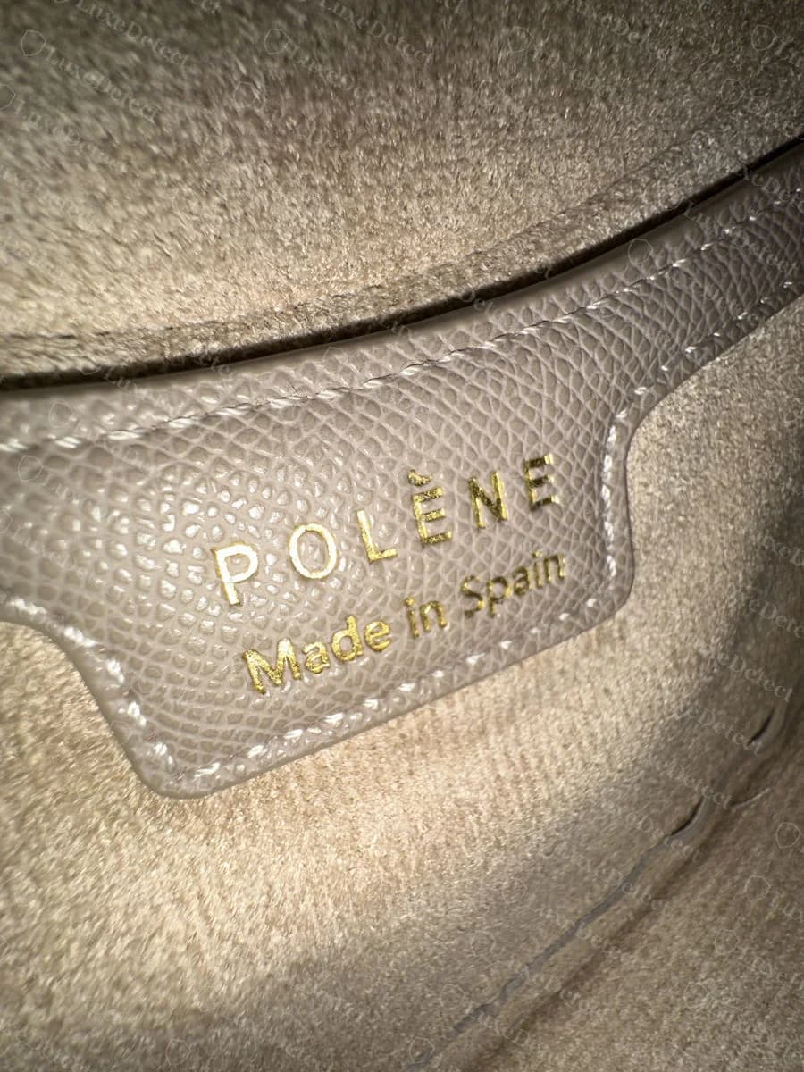 Counterfeit Numéro Dix interior tab: POLÈNE over Made in Spain in gold foil, the same format as the genuine mixed-case tab