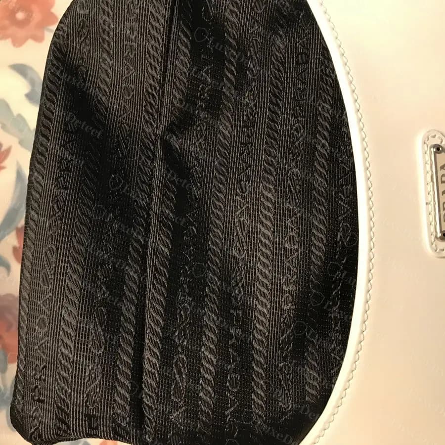 Authentic Cleo interior jacquard lining showing the woven rope-motif pattern and PRADA wordmark