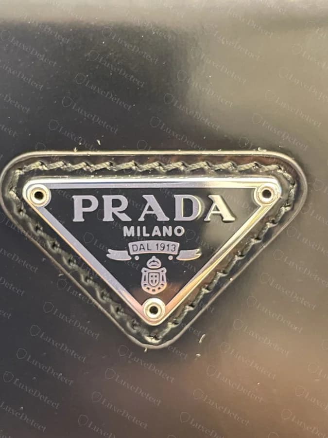 Authentic Cleo triangle plaque: silver lettering on black enamel, no color tint