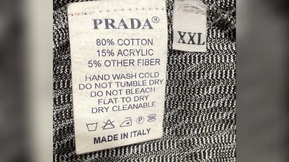 Counterfeit Prada knit sweater care label: "PRADA®", "80% COTTON 15% ACRYLIC 5% OTHER FIBER", "DRY CLEANABLE" and "MADE IN ITALY" on a single tag, with no Prada importer block.