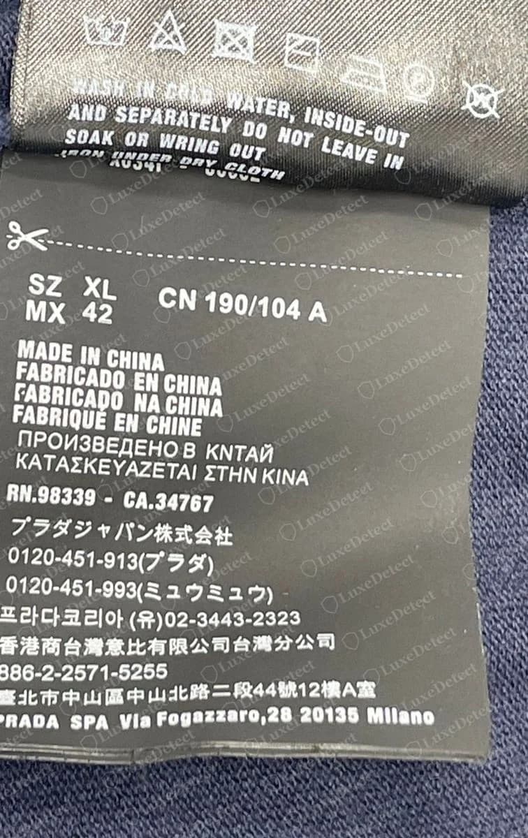 Genuine Prada polo care label: "MADE IN CHINA" in six languages, RN.98339 - CA.34767, Prada Japan (プラダジャパン株式会社) with both phone lines, Prada Korea, the Taiwan branch and Prada SpA in Milan.