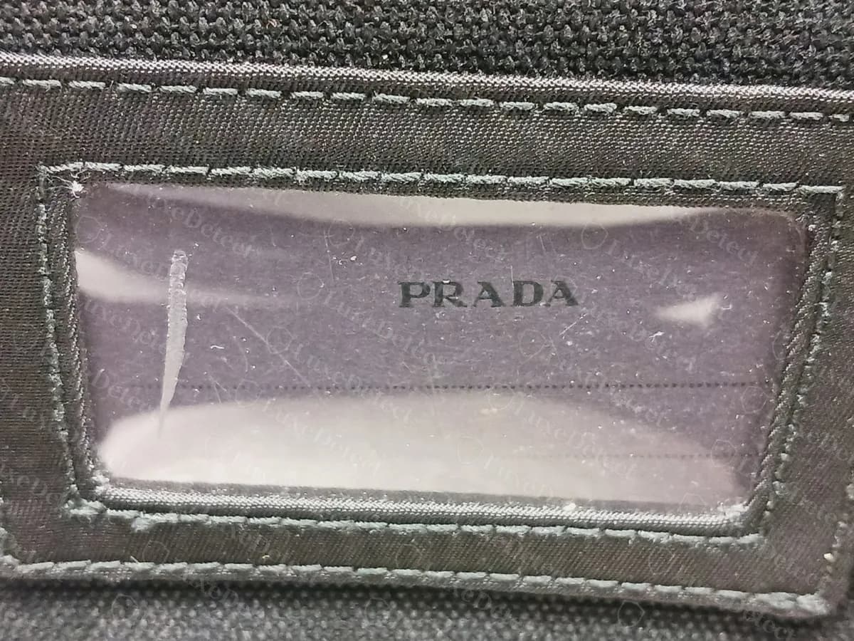 Genuine Prada backpack inner ID window: a clear plastic panel in a stitched frame with PRADA printed in the middle